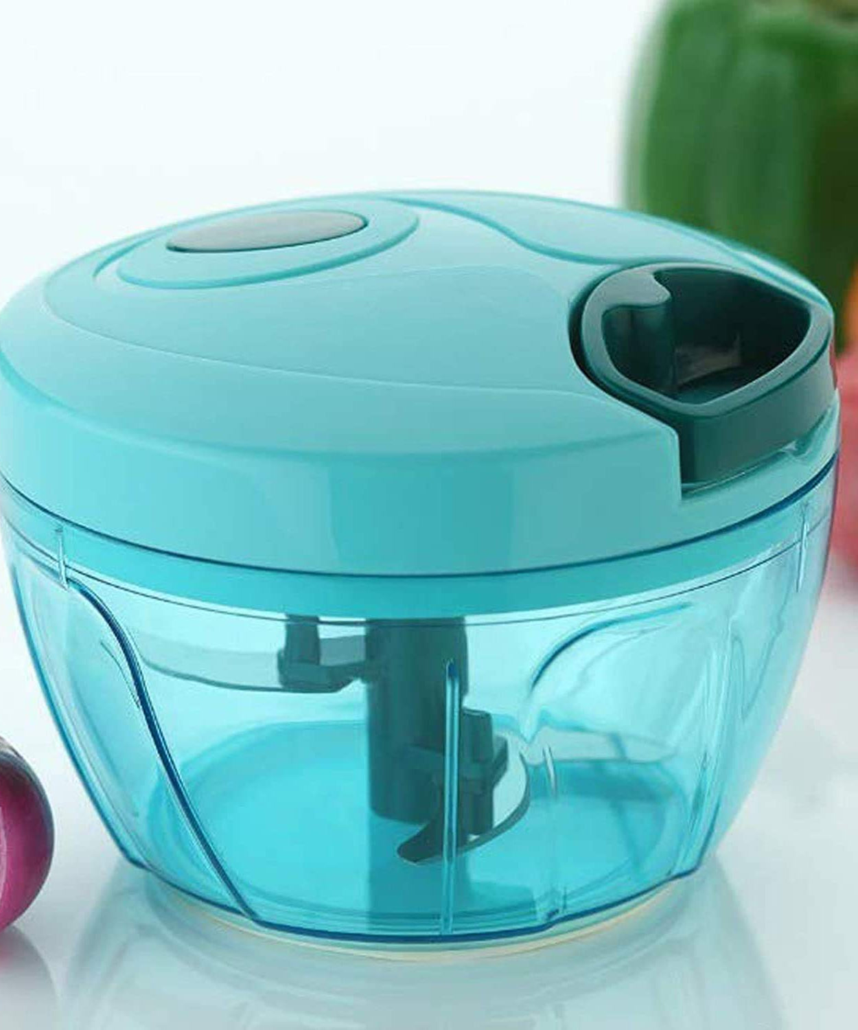 Compact hand-held vegetable chopper with stainless steel blades.