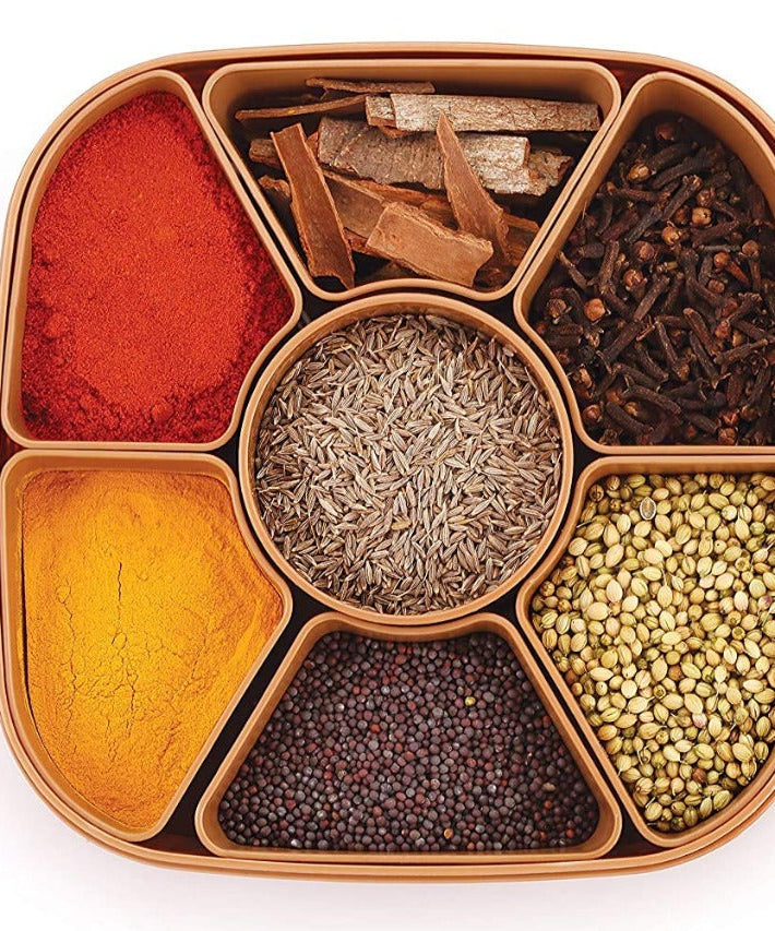 Multi-compartment masala box for organizing spices and herbs.