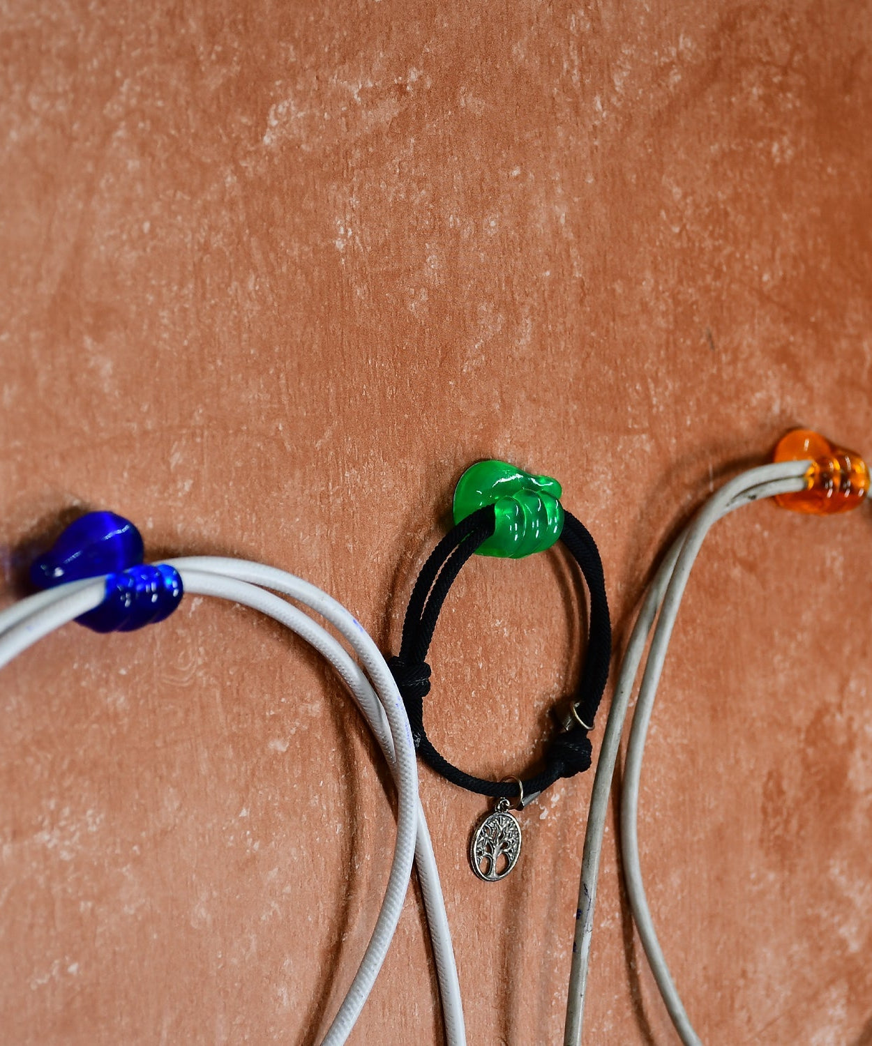 Wall-mounted hand shape clips for organizing.