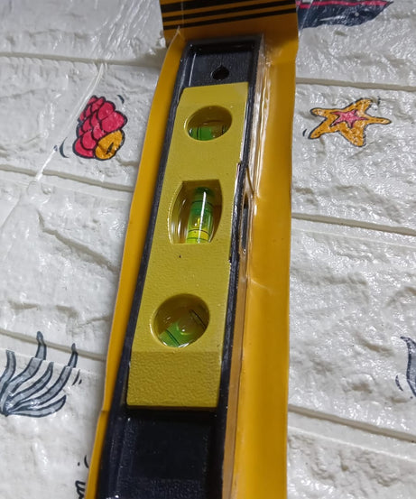 Handy mini level ruler with three bubble levels for quick use.