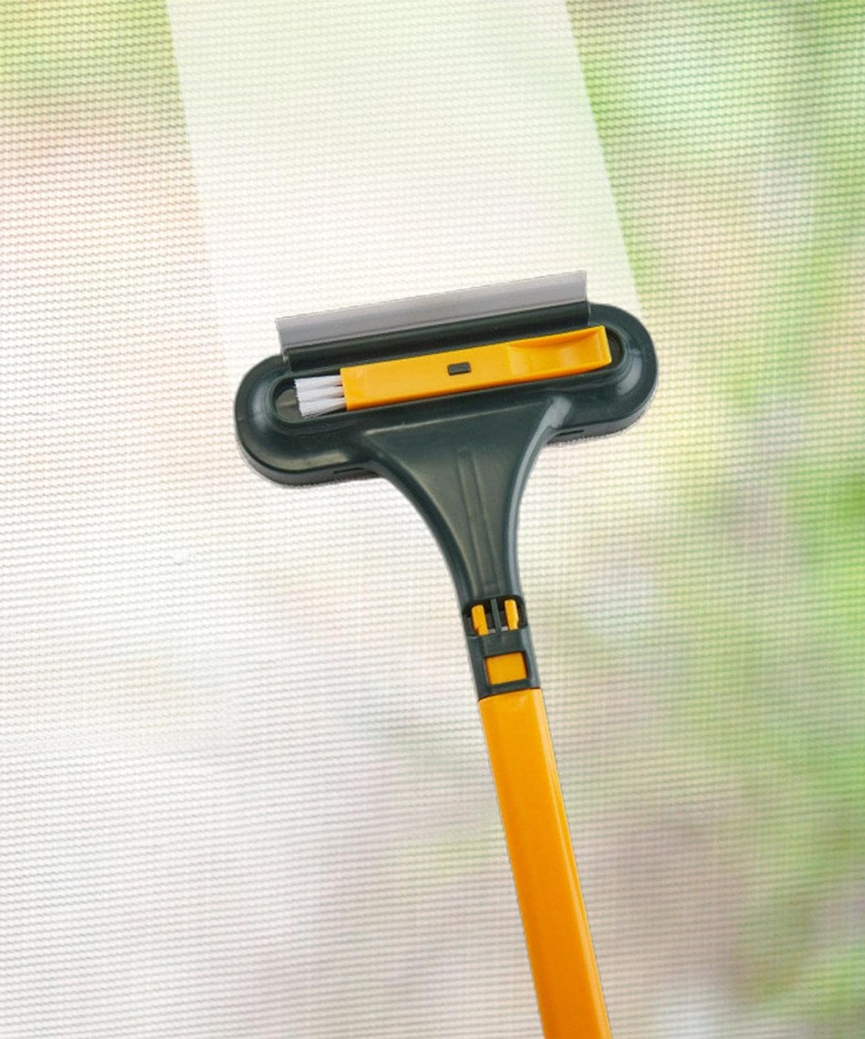 Mesh and glass cleaning squeegee with brush, compact and easy to use for home cleaning.