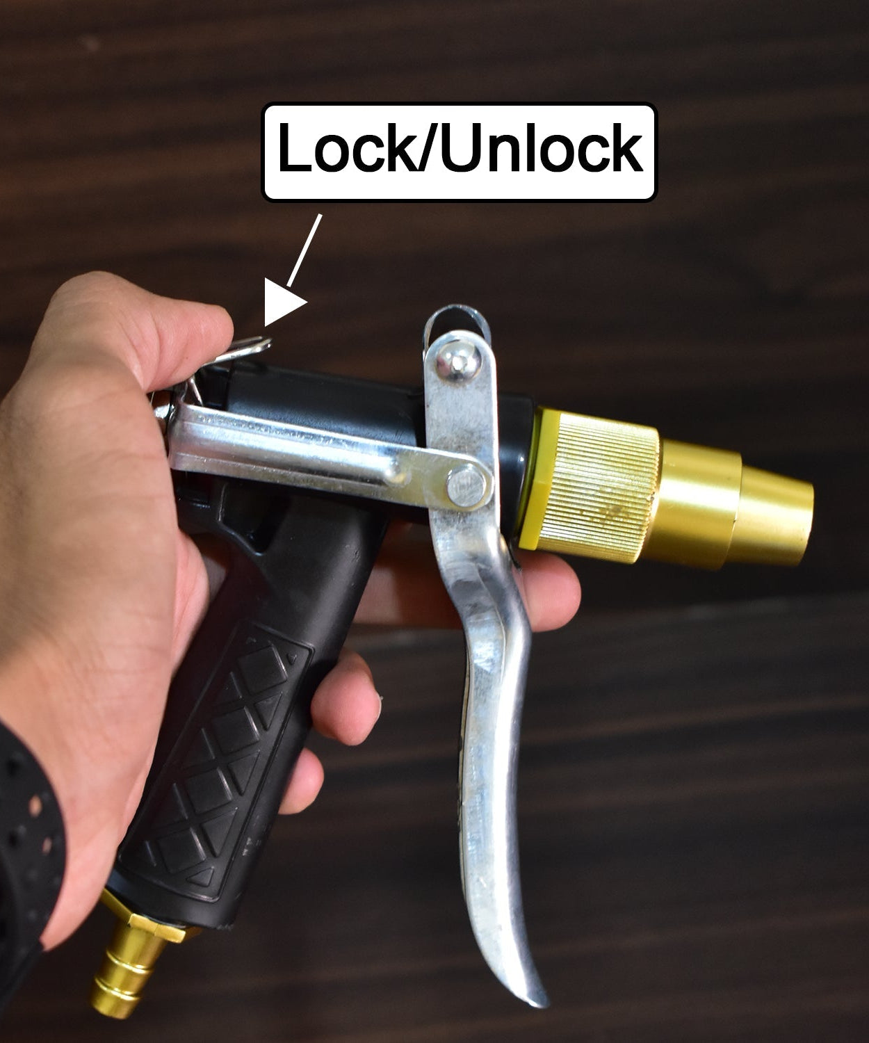 Durable gold trigger water nozzle, lever operated for efficient spraying.