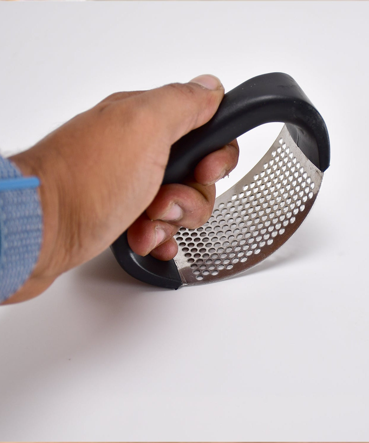 Easy-to-use garlic crusher with ergonomic handle and stainless steel build.