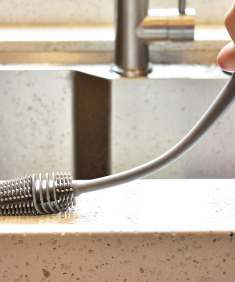 Brush with a long handle for bottle cleaning.