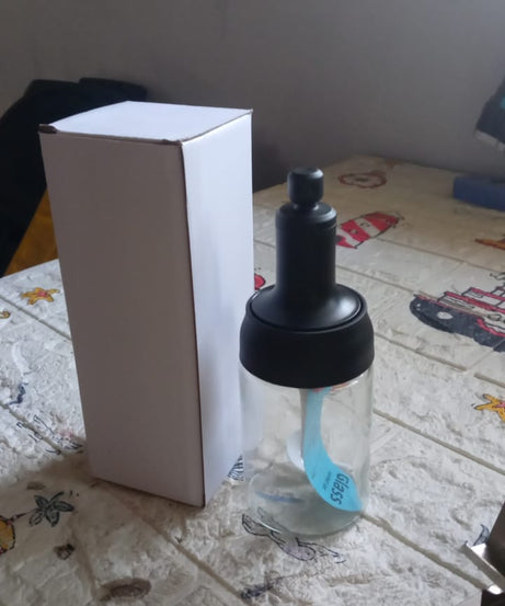 Kitchen seasoning jar with heat-resistant glass and spoon.